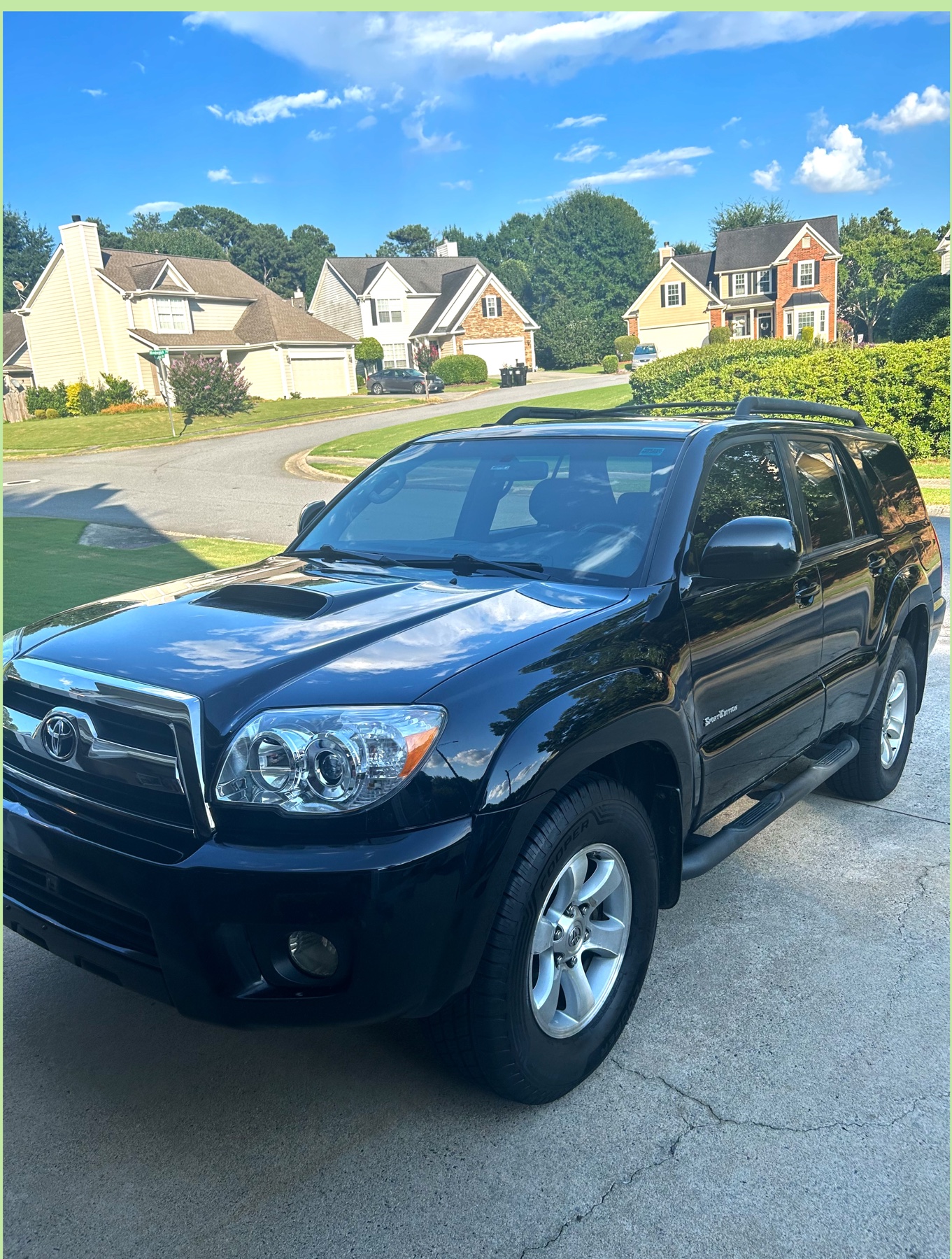 Black Toyota 4Runner with a glossy exterior finish in a driveway